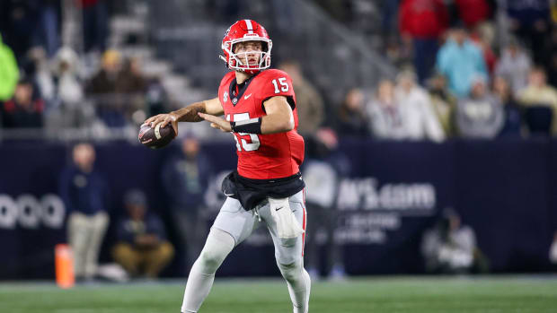 Nov 25, 2023; Atlanta, Georgia, USA; Georgia Bulldogs quarterback Carson Beck (15) drops back to pass against the Georgia Tech Yellow Jackets in the second half at Bobby Dodd Stadium at Hyundai Field. 